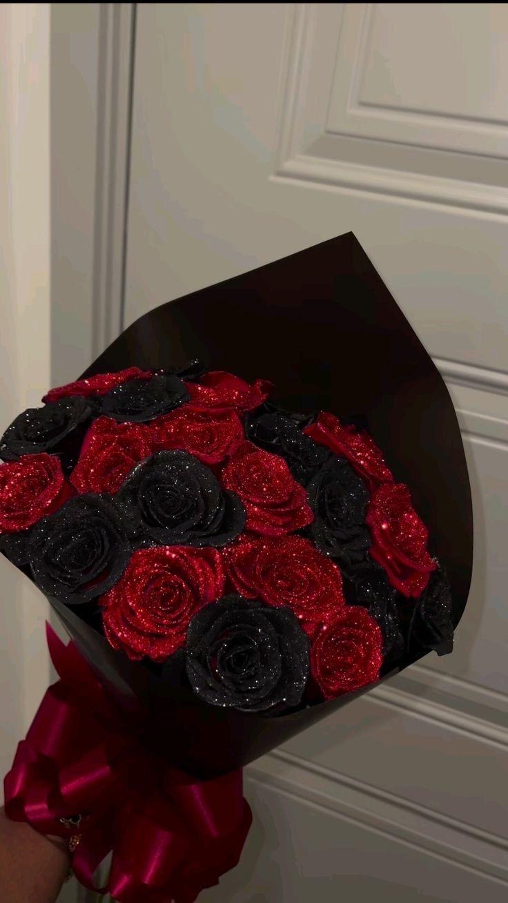 22 red and black roses with the black bouquet and the red ribbons